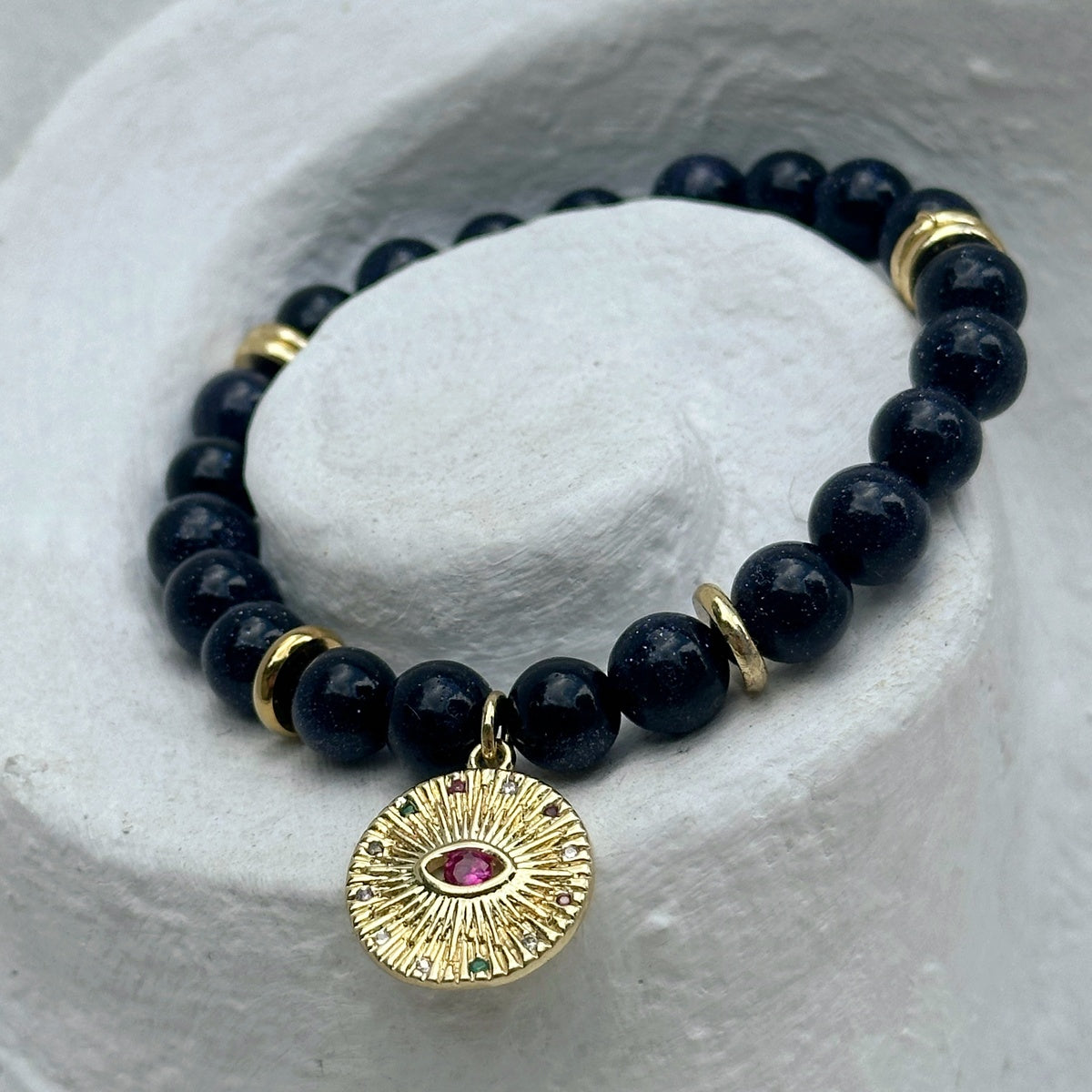 Black Goldstone Bracelet | Antique Gold Eye Charm & Pink Zirconia