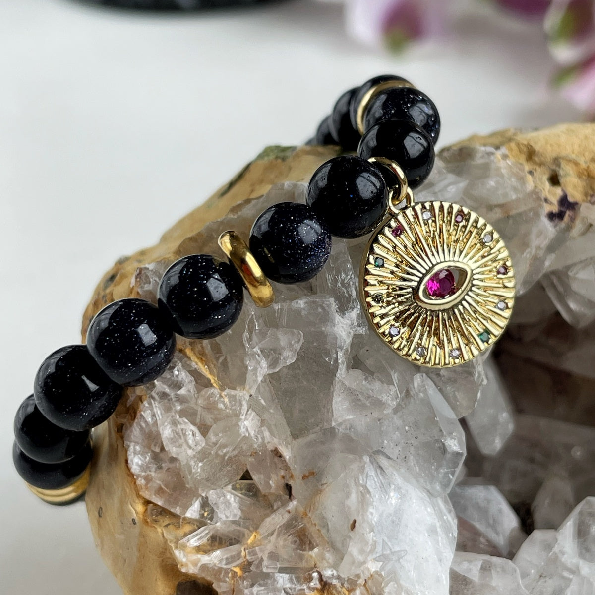 Black Goldstone Bracelet | Antique Gold Eye Charm & Pink Zirconia