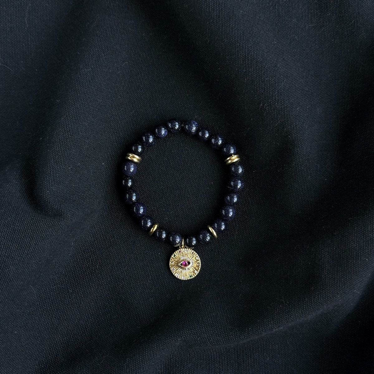 Black Goldstone Bracelet | Antique Gold Eye Charm & Pink Zirconia