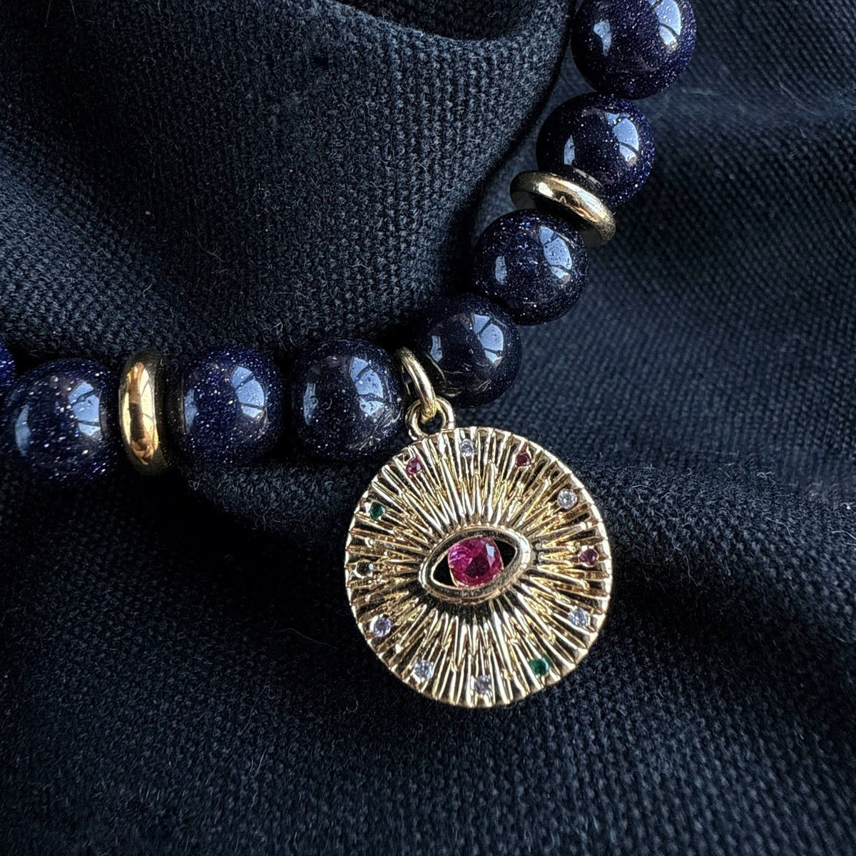 Black Goldstone Bracelet | Antique Gold Eye Charm & Pink Zirconia