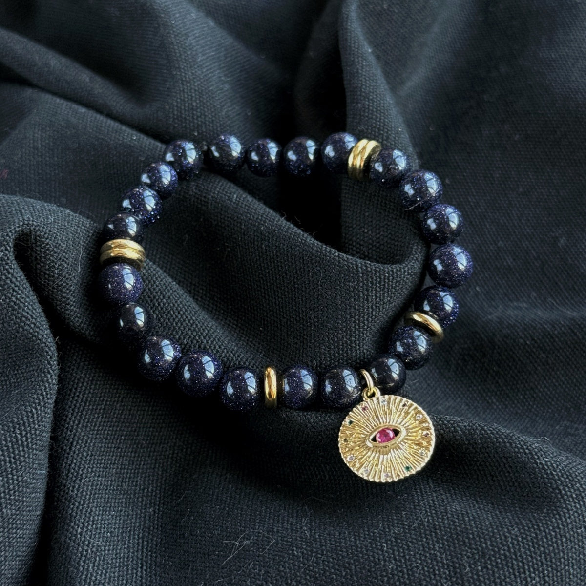 Black Goldstone Bracelet | Antique Gold Eye Charm & Pink Zirconia