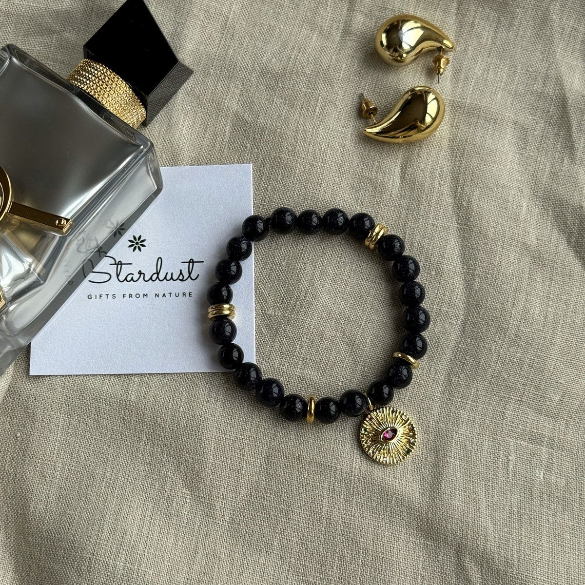 Black Goldstone Bracelet | Antique Gold Eye Charm & Pink Zirconia