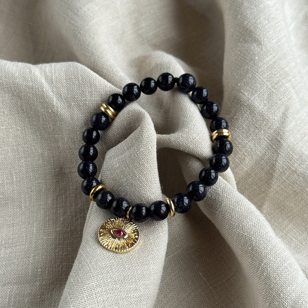Black Goldstone Bracelet | Antique Gold Eye Charm & Pink Zirconia