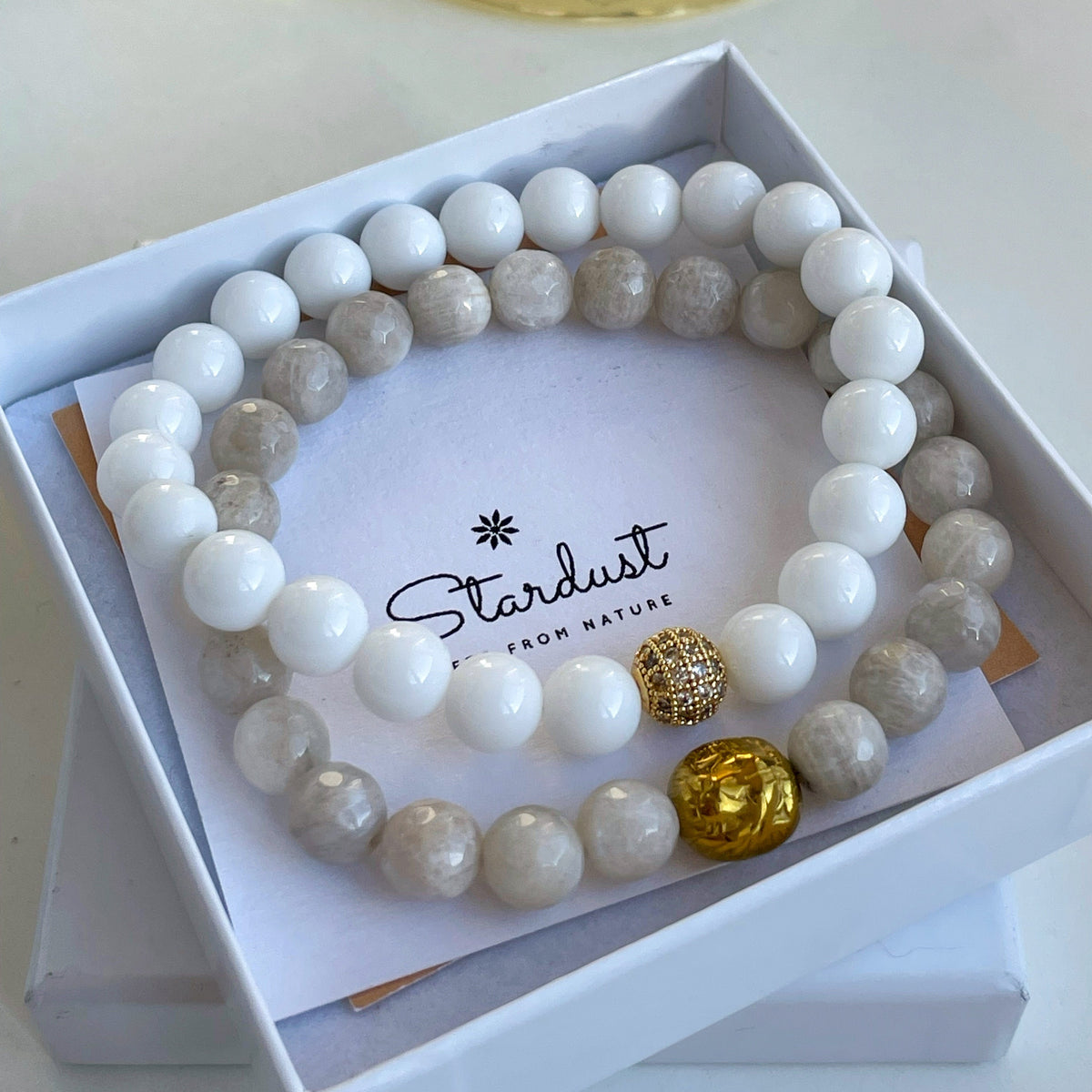 Moonstone and white agate bracelet set with gold lion charm