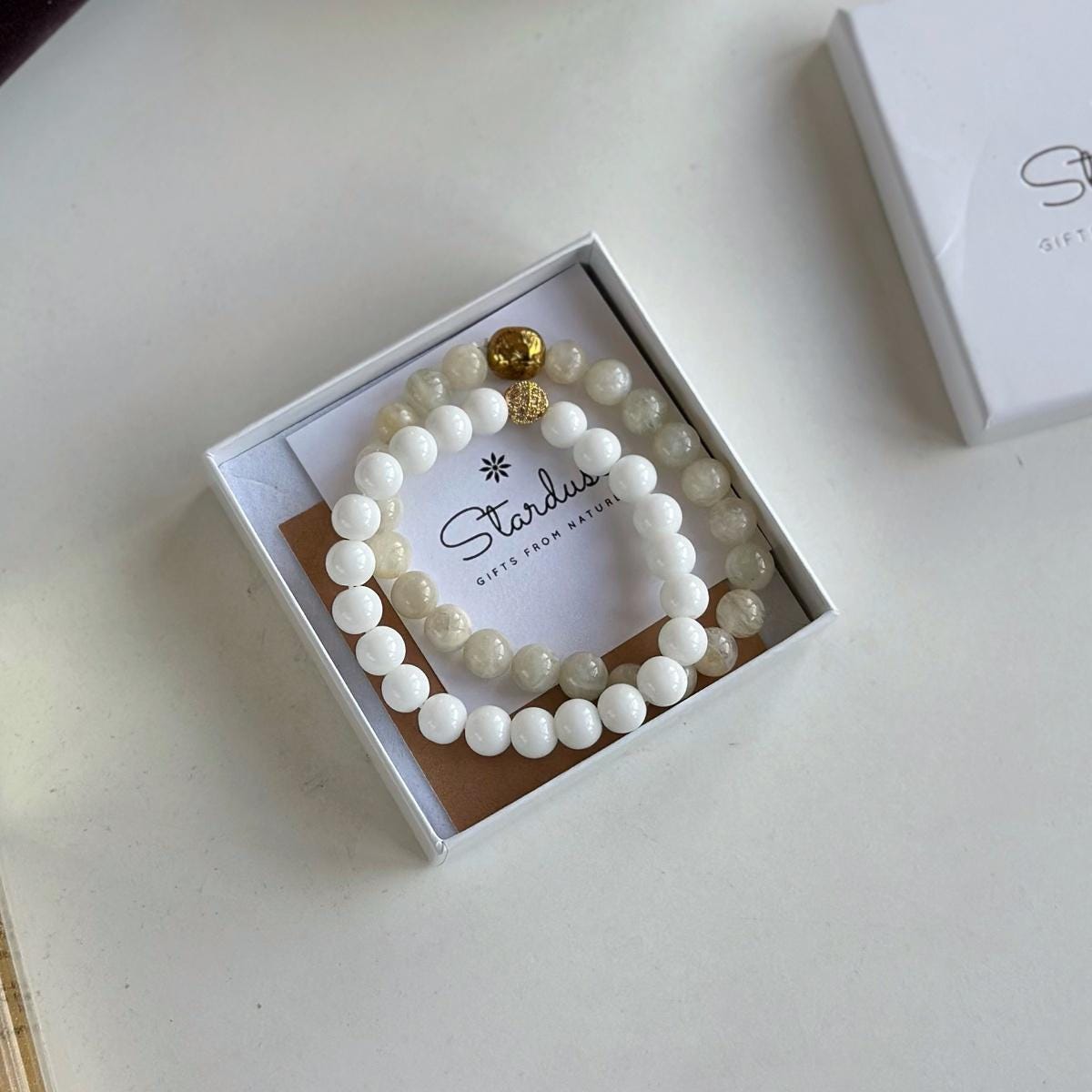Moonstone and white agate bracelet set with gold lion charm