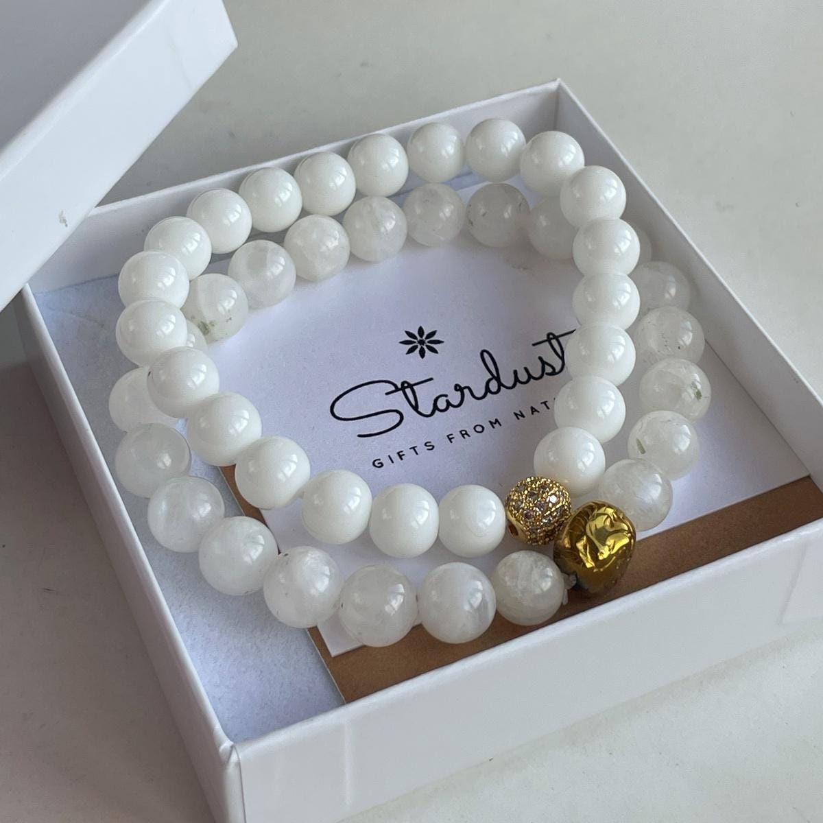 Moonstone and white agate bracelet set with gold lion charm