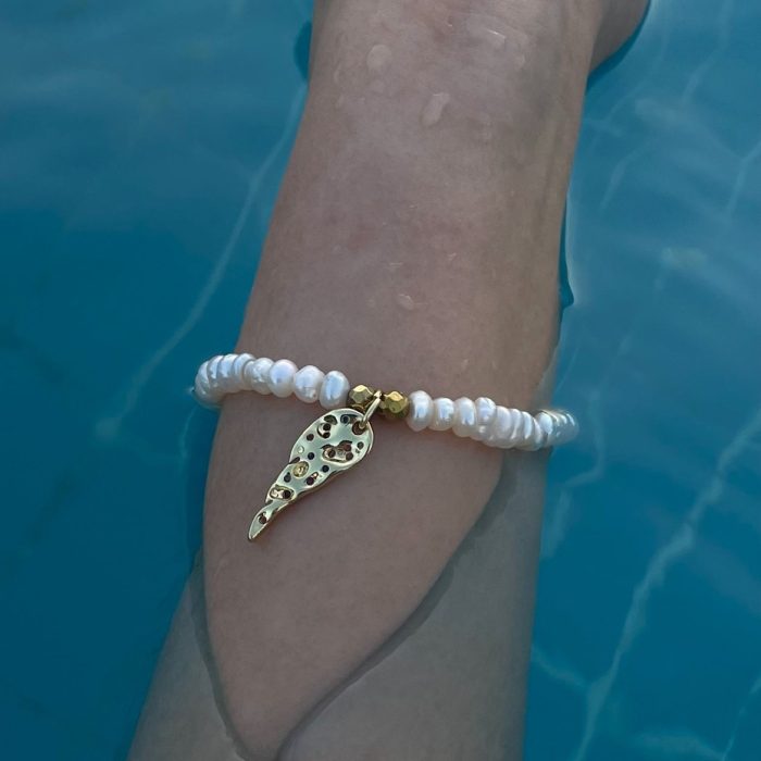 Delicate white pearl bracelet with gold charm