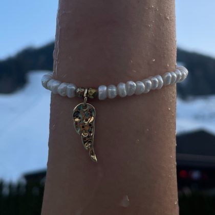 Delicate white pearl bracelet with gold feather charm