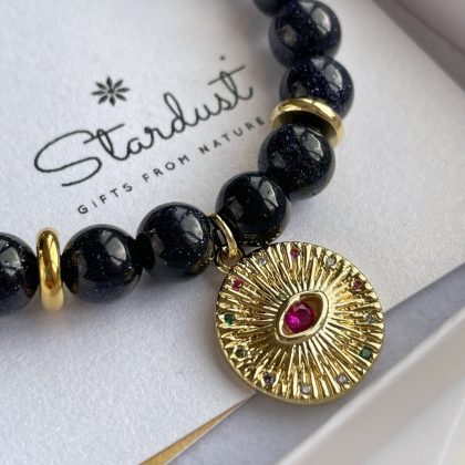 Blue Goldstone bracelet with large gold coin charm